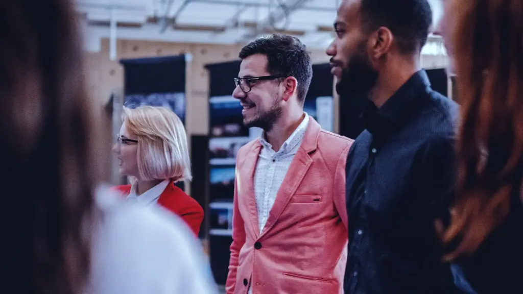 Two men listening intently and smiling.