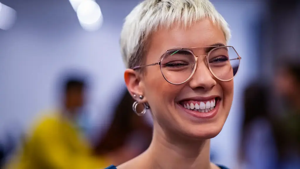 Woman in glasses smiling.