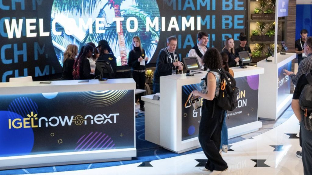 Now & Next registration desk. Attendees queue to get their event lanyard passes.