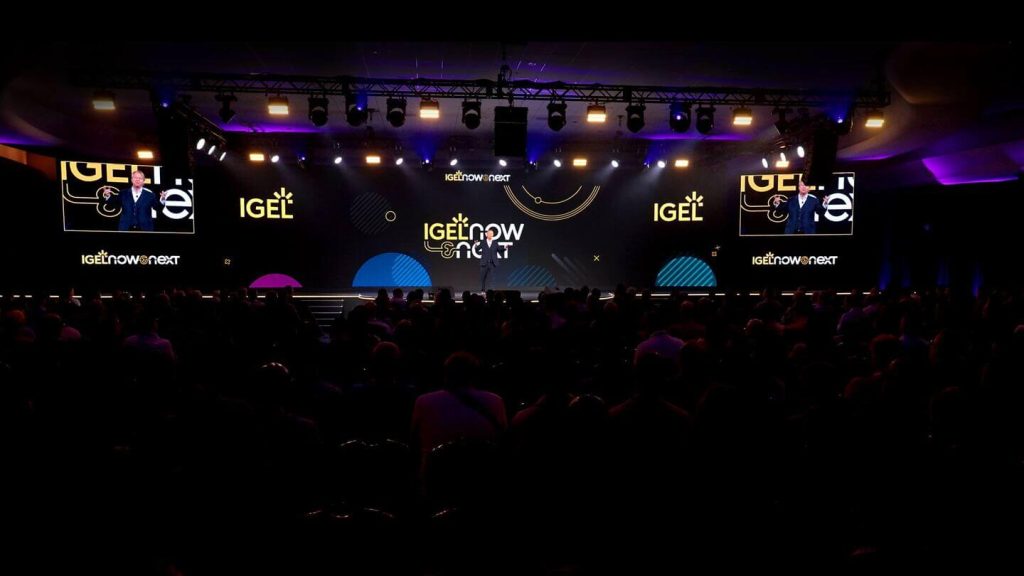 Now & next stage with speaker and screens.